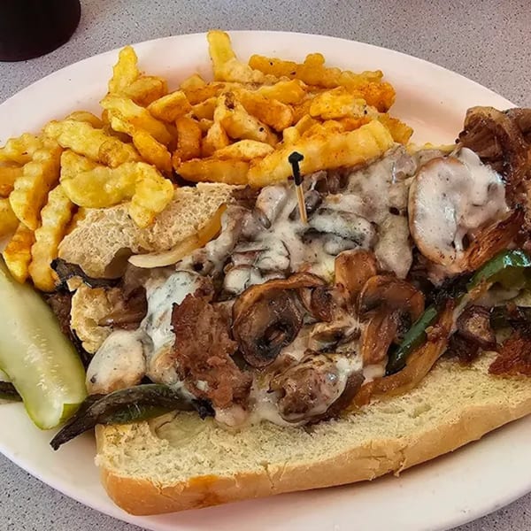 Joe's New York Diner's Philly cheesesteak with melted cheese, mushrooms, peppers, and crinkle-cut fries.